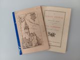 two old books sitting on top of a table next to each other