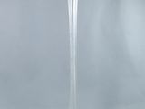 a tall glass vase that is sitting on a table