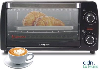 a toaster oven with a cup of coffee next to it