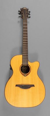 a close up of an acoustic guitar on a gray background