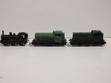 two toy trains sitting on a white surface next to each other