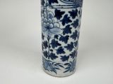 a blue and white vase sitting on a white surface