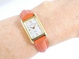 a woman ' s wrist that has a watch on it