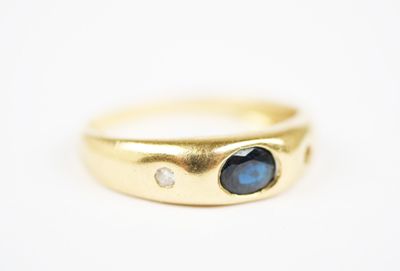 a close up of a gold ring with a blue stone