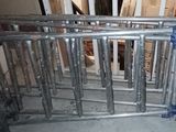 an image of a baby crib made of metal pipes