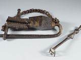 a small metal object with a chain attached to it