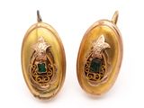 pair of gold and emerald earrings on a white background