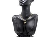 a close up of a mannequin head with a necklace on it