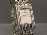 a close up of a wrist watch on a clear stand