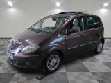 a picture of a small brown car parked in a garage