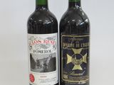 two bottles of wine sitting next to each other on a table