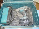 a blue tool box with tools in it on a table