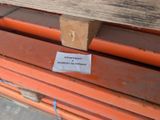 a sticker on a piece of wood that is sitting on a pallet