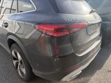 the rear end of a black mercedes suv parked in a parking lot