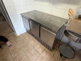 une femme debout dans une cuisine, près d'un plan de travail