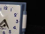 a small clock that is sitting on a table
