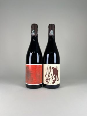 two bottles of wine sitting next to each other on a table