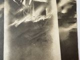 a black and white photo of a man on a boat in the water