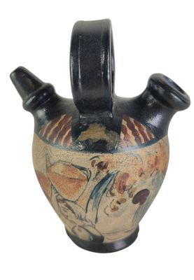 a black vase with a design on it on a white background