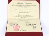 a red and white certificate on a red card
