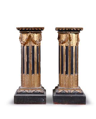 pair of antique black and gold columns on marble bases