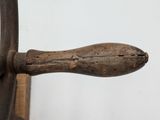 a close up of a wooden handle on a chair
