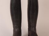 pair of black leather riding boots on a white background