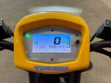 a close up of a yellow motorcycle with a clock on it