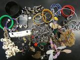 many different types of bracelets and rings on the table