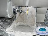 a machine that is making dough in a kitchen