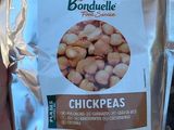 un sac de pois chiches dans la main d'une personne