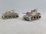 two toy tanks sitting side by side on a table