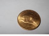 a gold coin sitting on top of a white surface