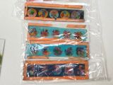 five different colored pencils in plastic bags on a table