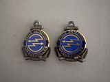 two blue and silver badges with the letters e and f on them