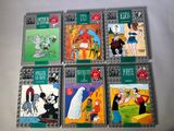 six livres pour enfants sont alignés sur une surface blanche