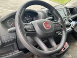 the interior of a car with a steering wheel and dashboard controls