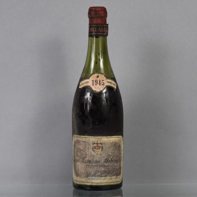une vieille bouteille de vin posée sur une table en verre
