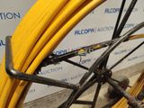 a close up of a yellow hose attached to a bicycle wheel