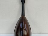 a mandolin hanging on the wall next to a white wall