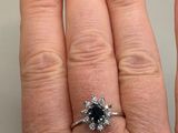a close up of a person ' s hand with a ring on it