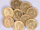 a pile of gold coins on a white surface