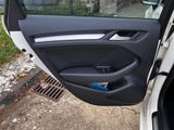 a car door with the door handle open and a phone in it
