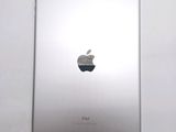 an apple ipad sitting on top of a white table next to a white wall