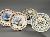 four plates with different designs on them sitting on a gray surface