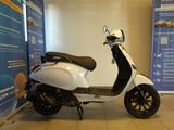 a scooter that is parked in front of a wall