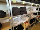 a lot of clothes on the shelves in the room