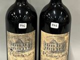 two bottles of wine sitting next to each other on a table