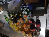 many different types of sodas and soda bottles on the counter