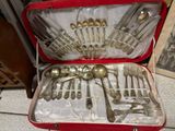 a red case with silverware in it on the floor